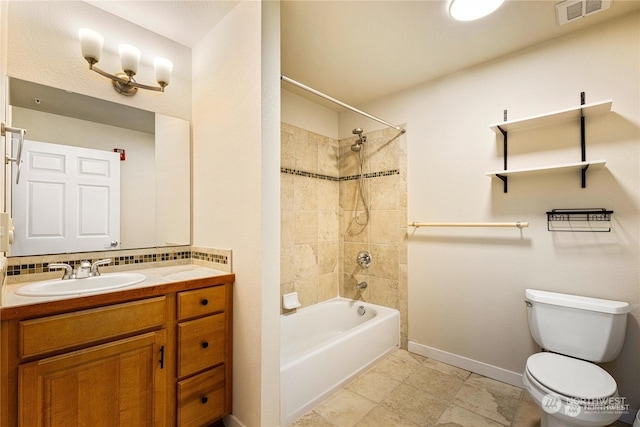 full bathroom with vanity, toilet, and tiled shower / bath combo