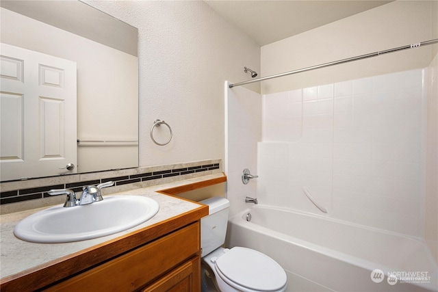 full bathroom with vanity, decorative backsplash, shower / bathing tub combination, and toilet