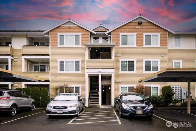 view of property featuring a carport and a balcony