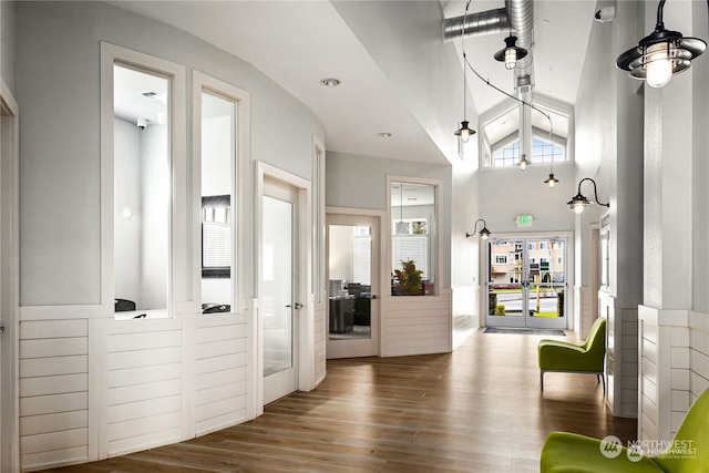 foyer entrance featuring hardwood / wood-style floors and vaulted ceiling