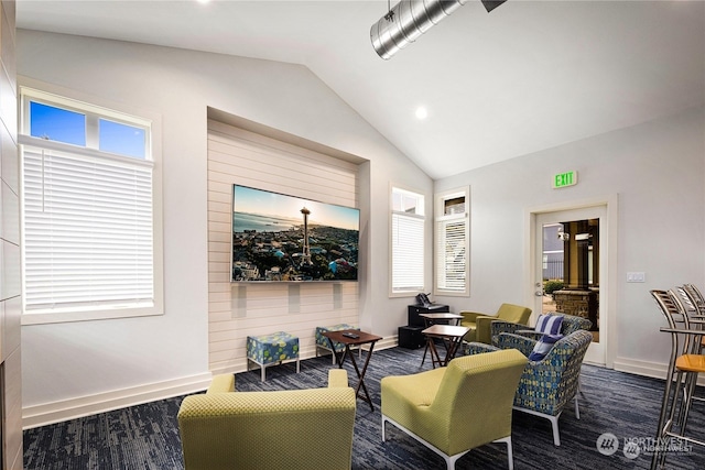 living room featuring a healthy amount of sunlight and vaulted ceiling