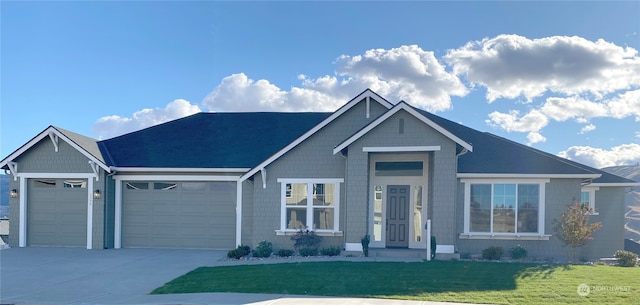 view of front of house with a front lawn and a garage