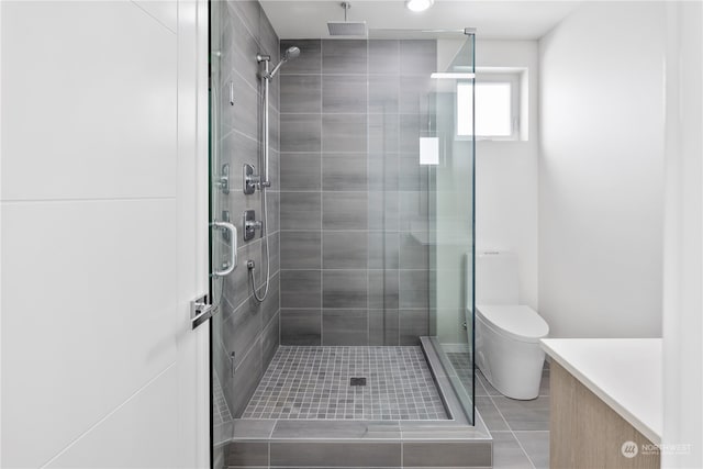 bathroom featuring toilet, a shower with door, vanity, and tile patterned flooring