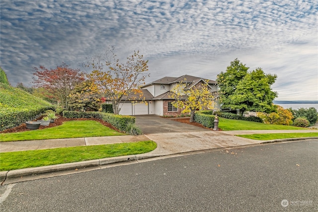 view of front of house with a front yard and a garage