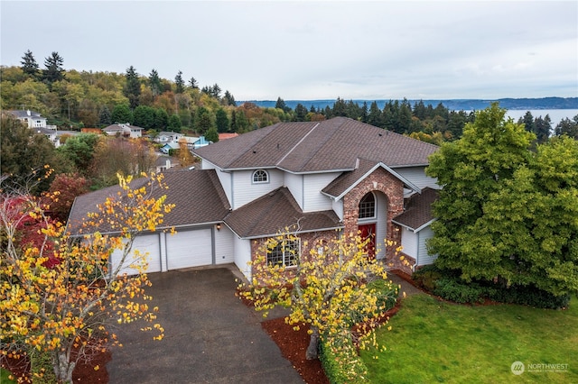 view of front of home with a front yard and a garage