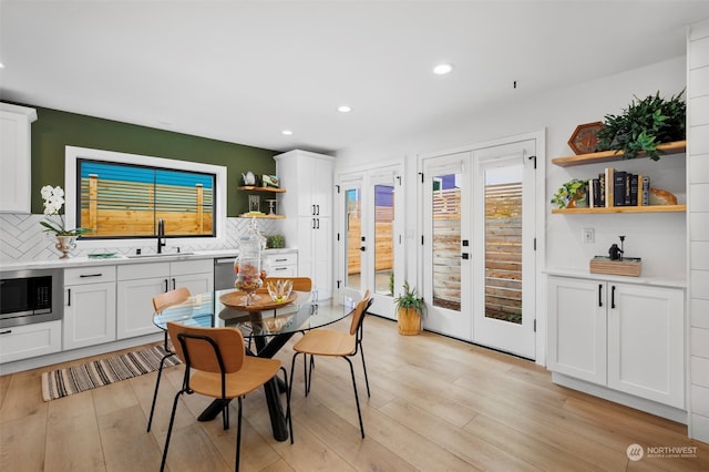 dining area featuring light hardwood / wood-style floors and sink