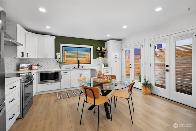 kitchen with white cabinetry, stainless steel appliances, and plenty of natural light