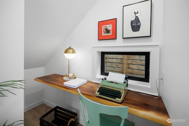 office with hardwood / wood-style flooring and lofted ceiling