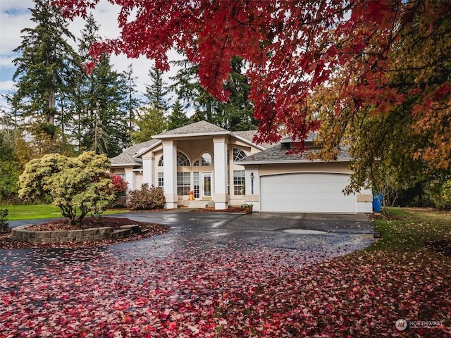 view of front of home with a porch and a garage