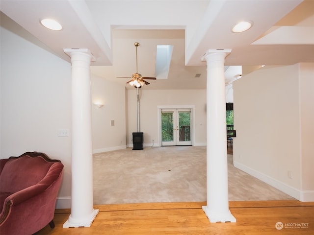 living room with ornate columns, ceiling fan, and carpet flooring