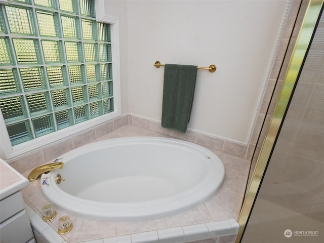 bathroom with vanity and independent shower and bath