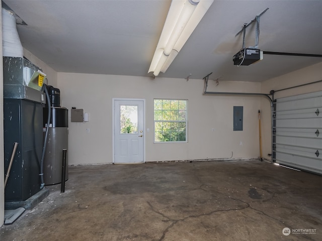 garage with a garage door opener and electric panel