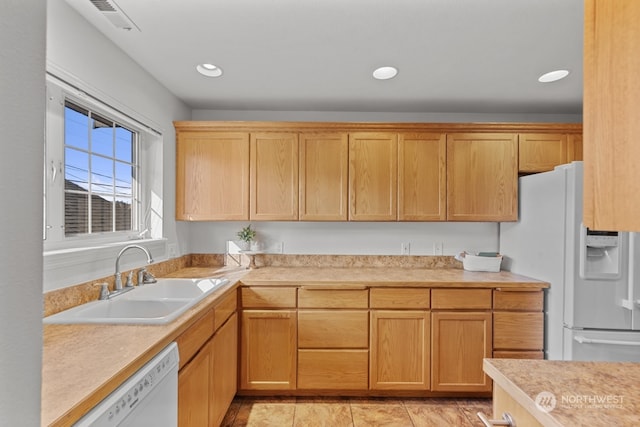 kitchen with white appliances, light tile patterned flooring, and sink