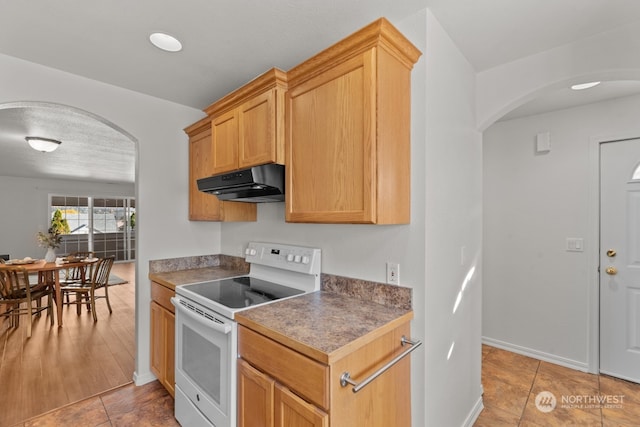 kitchen with light tile patterned flooring and white range with electric cooktop