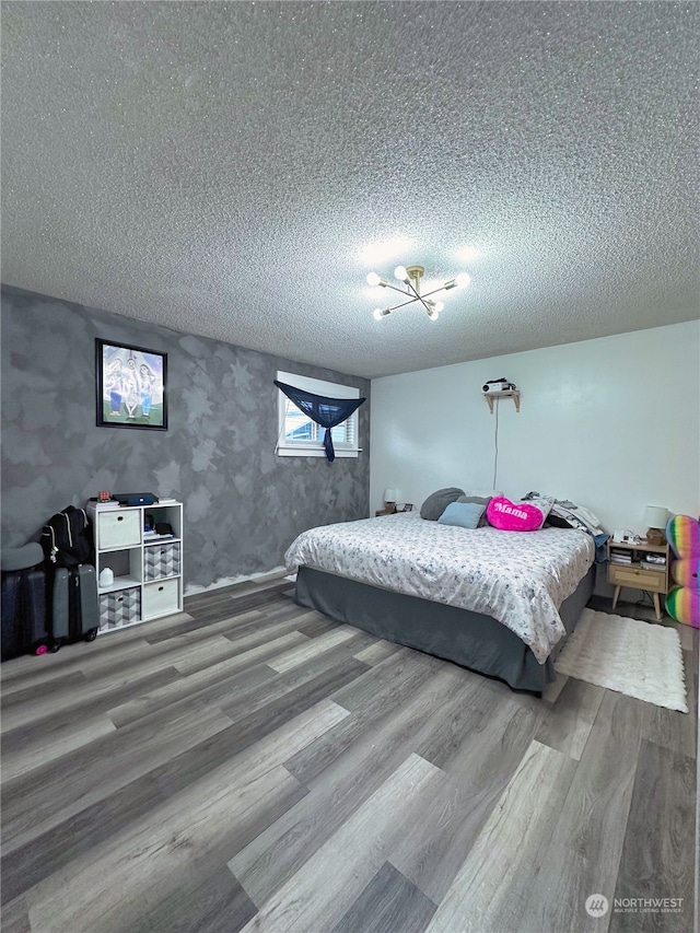 bedroom featuring a textured ceiling and hardwood / wood-style floors