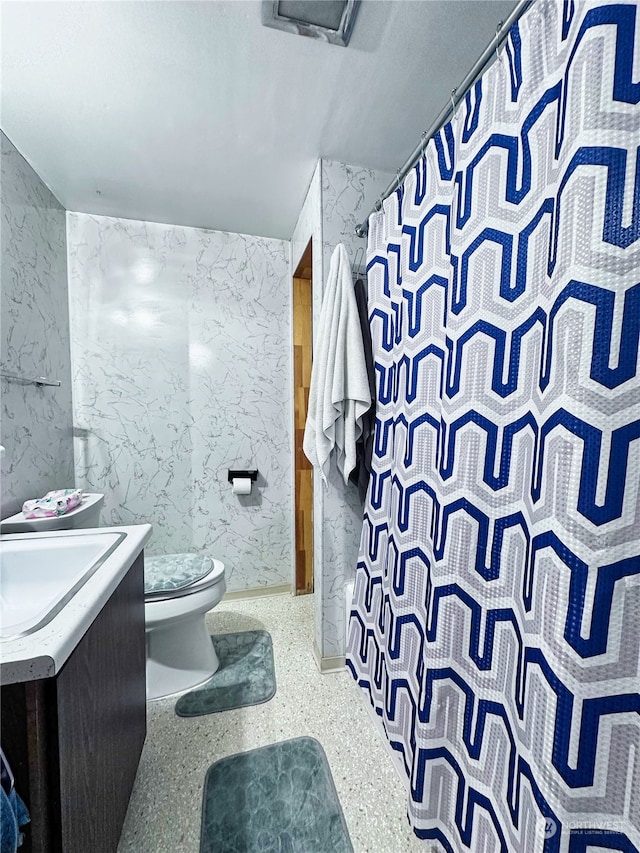 bathroom featuring vanity, toilet, and a shower with shower curtain