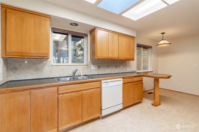 kitchen with sink, backsplash, dishwasher, and decorative light fixtures