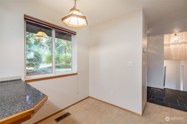 unfurnished dining area with carpet