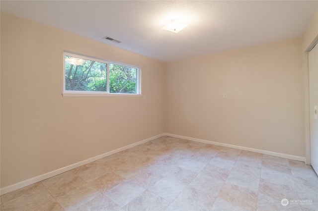 empty room with a textured ceiling