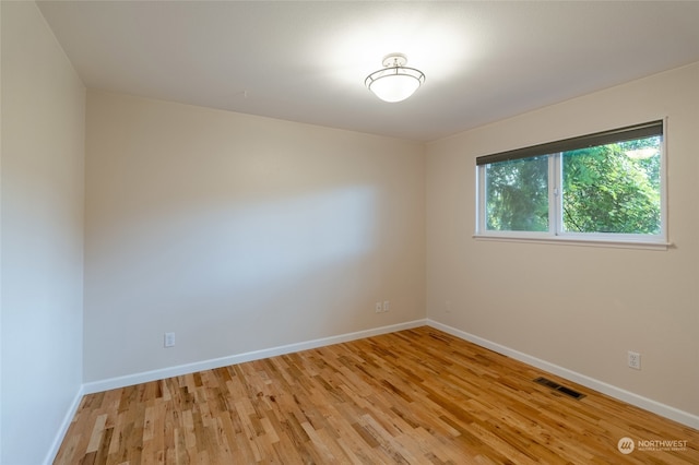 spare room featuring light hardwood / wood-style floors