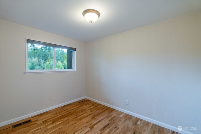 spare room with light hardwood / wood-style flooring