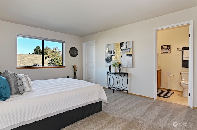 bedroom with light colored carpet and connected bathroom