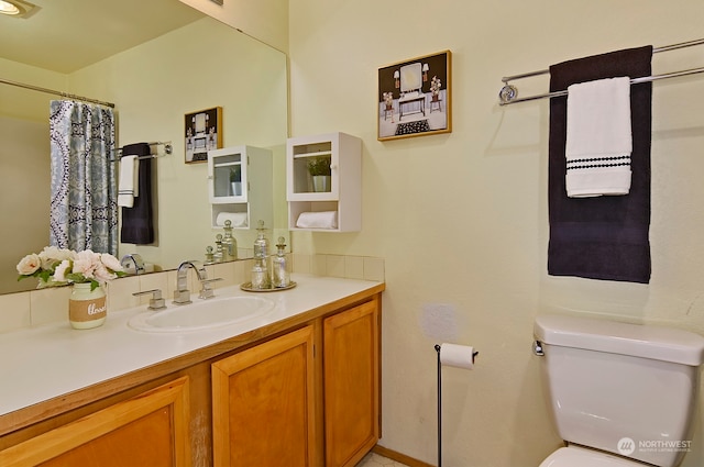 bathroom with toilet and vanity