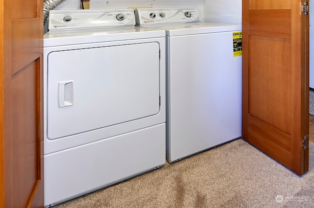 laundry area with light colored carpet and washing machine and clothes dryer