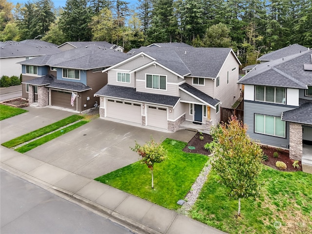 view of front of property with a garage and a front lawn