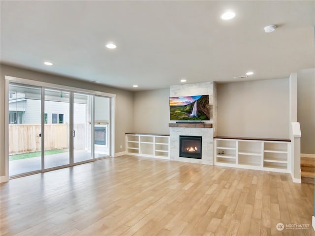 unfurnished living room with light hardwood / wood-style flooring and a fireplace