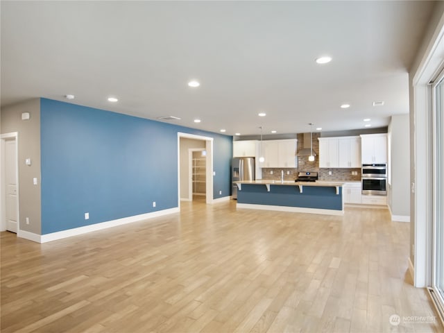 unfurnished living room featuring light hardwood / wood-style floors