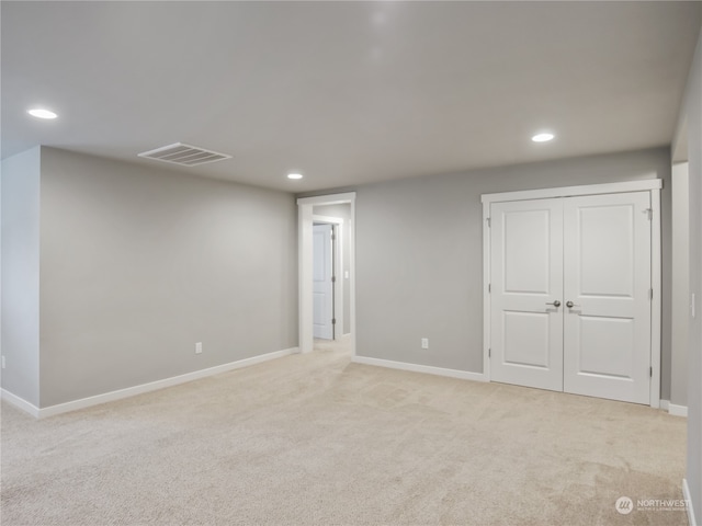 basement featuring light carpet