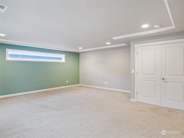 basement featuring light colored carpet