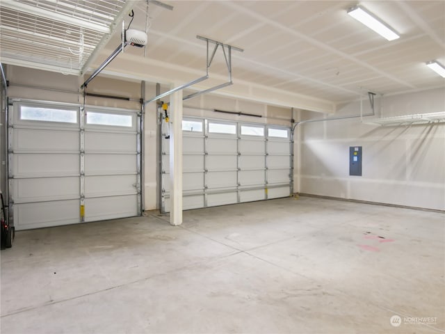 garage featuring a garage door opener and electric panel