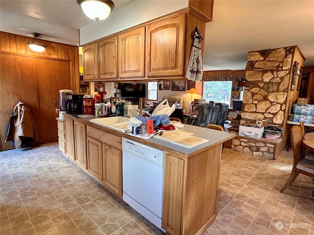 1410 E Sanpoil Rd, Keller, WA 99140 - kitchen featuring white dishwasher, wooden walls, brown cabinetry, and light stone finish flooring
