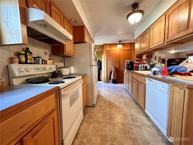 kitchen with white appliances and backsplash