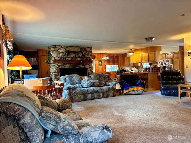 living room featuring a fireplace, light colored carpet, and wood walls