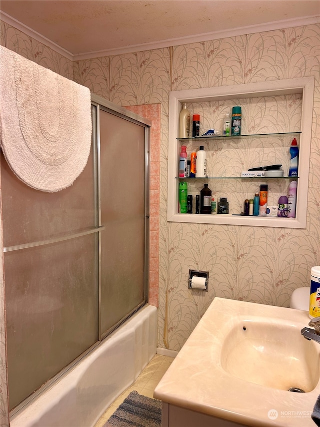 bathroom with tile patterned floors, vanity, enclosed tub / shower combo, and ornamental molding