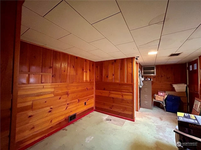 basement featuring wooden walls