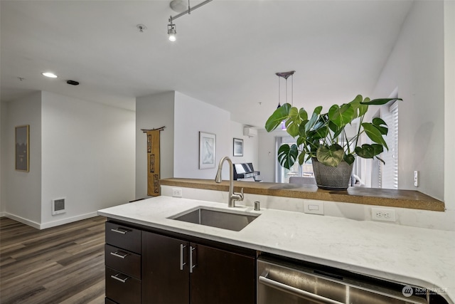 kitchen featuring stainless steel dishwasher, sink, dark brown cabinetry, and dark hardwood / wood-style floors