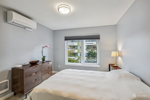 bedroom with an AC wall unit and carpet