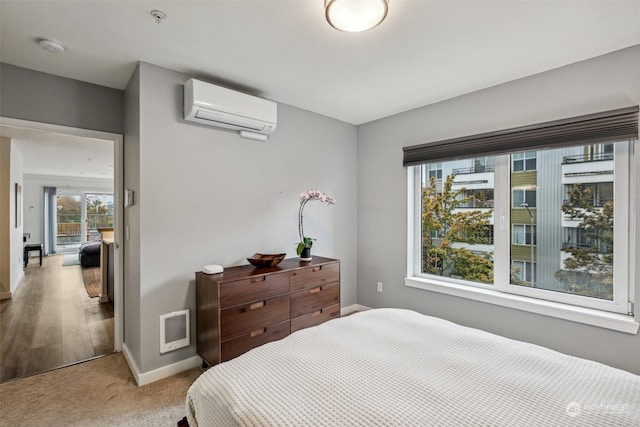 carpeted bedroom featuring an AC wall unit