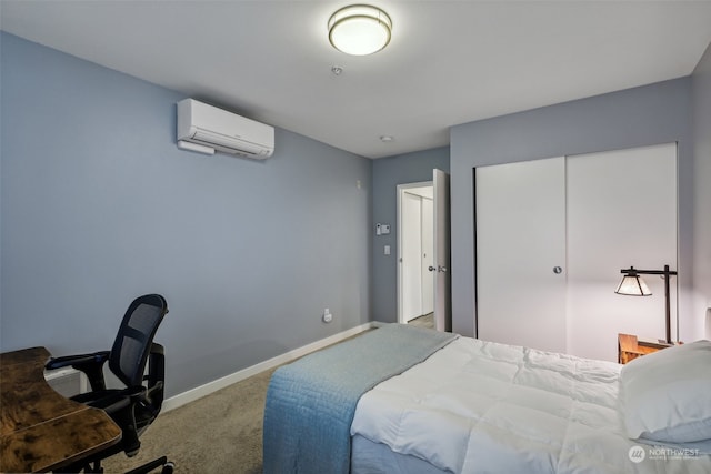 bedroom with a closet, carpet flooring, and a wall mounted air conditioner