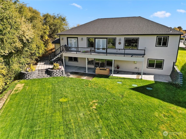 rear view of property featuring a patio and a lawn