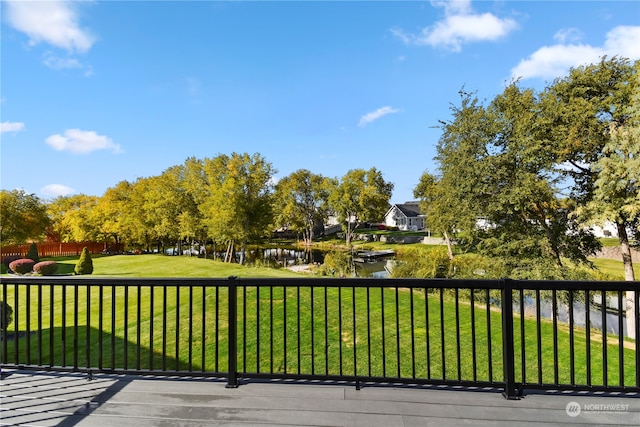 view of home's community with a yard and a water view