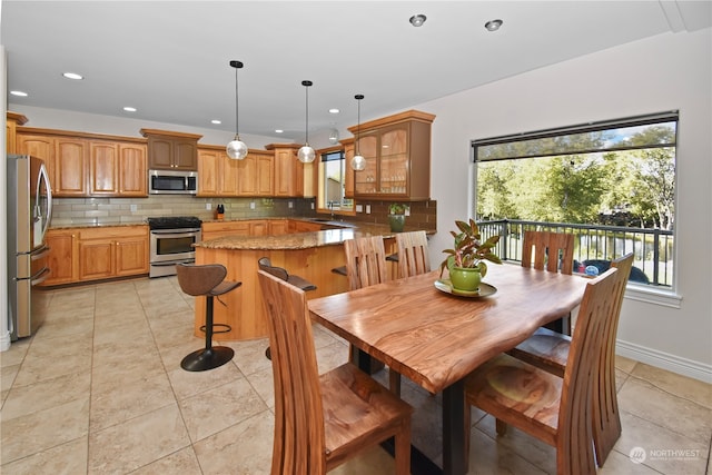 dining room featuring sink and light tile patterned flooring