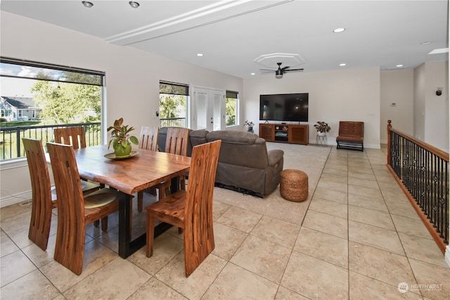 tiled dining room with plenty of natural light and ceiling fan