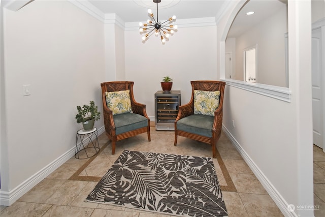 sitting room with crown molding, light tile patterned flooring, an inviting chandelier, and beverage cooler