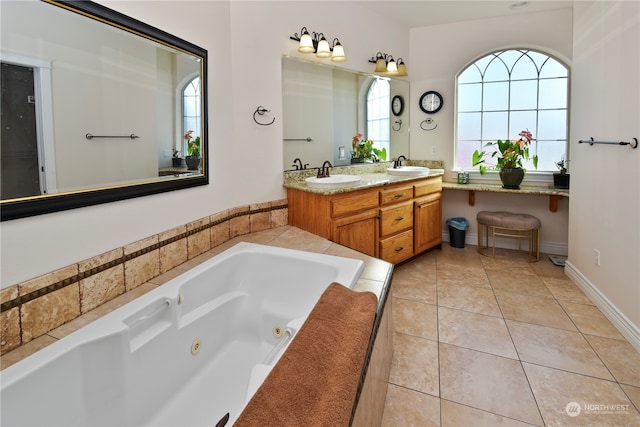 bathroom with vanity, a tub, and tile patterned floors