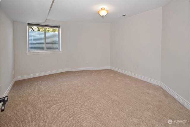 unfurnished room featuring light colored carpet